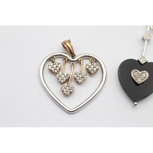 1053 - Two 9ct gold diamond set heart shaped pendants - approx. gross weight 6.5 grams