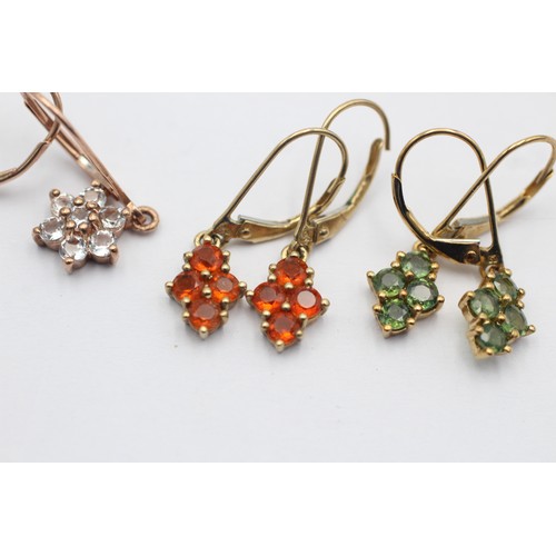 1055 - Three pairs of 9ct gold gemstone cluster earrings, one fire opal, one green sapphire and one clear g... 