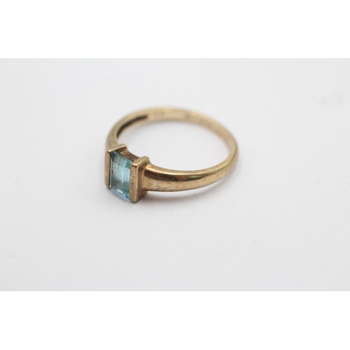 1090 - A 9ct gold baguette cut topaz solitaire ring, size L½ - approx. gross weight 1.6 grams