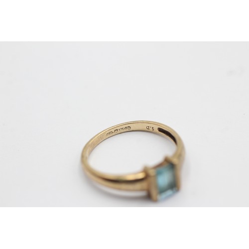 1090 - A 9ct gold baguette cut topaz solitaire ring, size L½ - approx. gross weight 1.6 grams