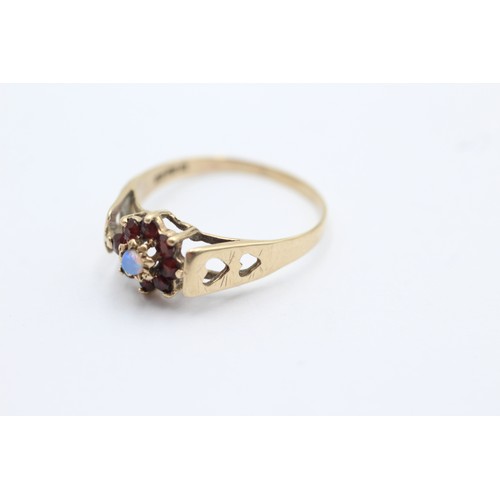 1093 - A 9ct gold garnet and opal halo ring with heart shape shank, size T - approx. gross weight 2 grams