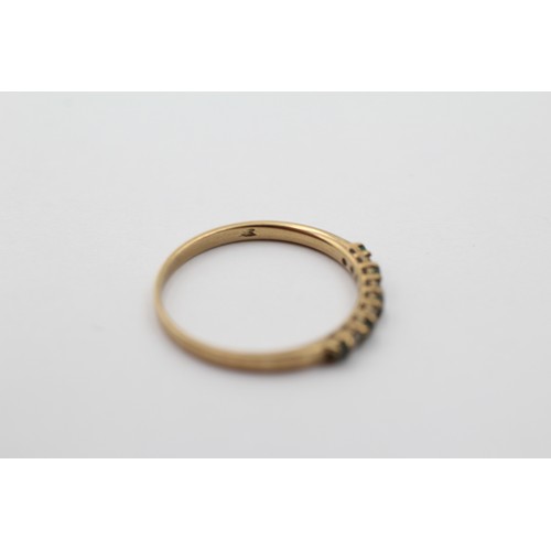 1099 - A 9ct gold diamond and green gemstone half eternity ring, size N - approx. gross weight 1 gram