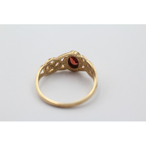 1100 - A 9ct gold oval cut garnet solitaire ring with openwork shank, size P½ - approx. gross weight 2 gram... 