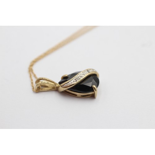 1108 - A 9ct gold diamond and sapphire teardrop pendant necklace - approx. gross weight 2.1 grams