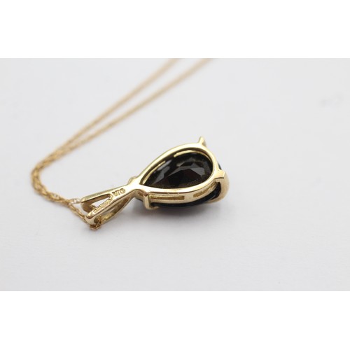 1108 - A 9ct gold diamond and sapphire teardrop pendant necklace - approx. gross weight 2.1 grams