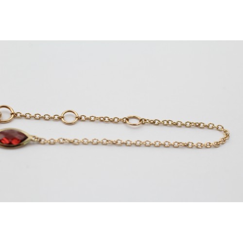 1121 - A 9ct gold marquise cut garnet bracelet - approx. gross weight 0.8 grams