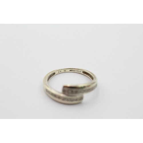 1124 - A 9ct gold diamond bypass ring, size M½ - approx. gross weight 2.2 grams