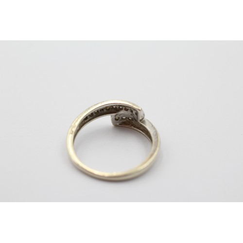 1124 - A 9ct gold diamond bypass ring, size M½ - approx. gross weight 2.2 grams