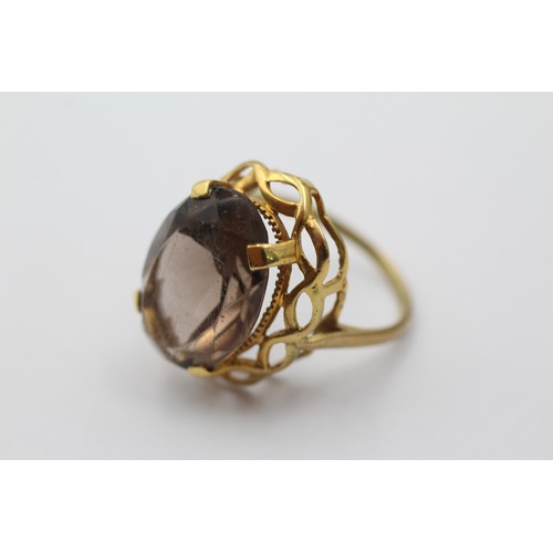 1143 - A 9ct gold smoky quartz cocktail ring with openwork frame, size P - approx. gross weight 5.1 grams