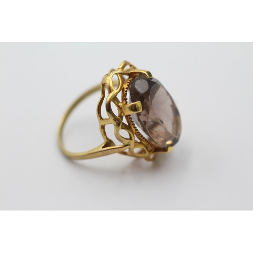 1143 - A 9ct gold smoky quartz cocktail ring with openwork frame, size P - approx. gross weight 5.1 grams