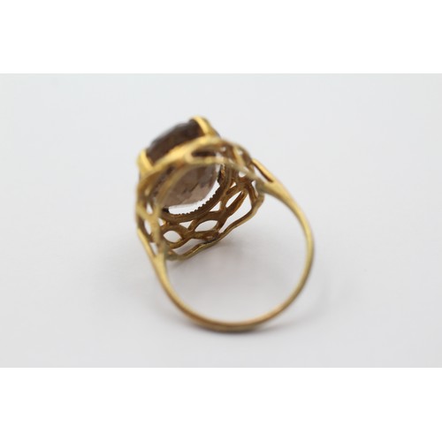 1143 - A 9ct gold smoky quartz cocktail ring with openwork frame, size P - approx. gross weight 5.1 grams