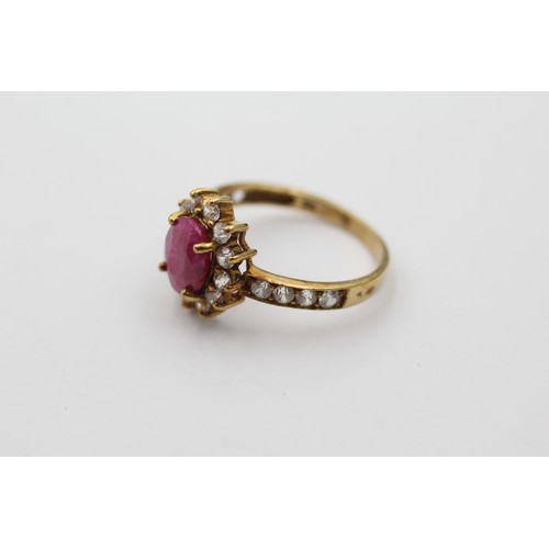 1147 - A 9ct gold ruby and clear gemstone halo ring with clear gemstone set shank, size L - approx. gross w... 