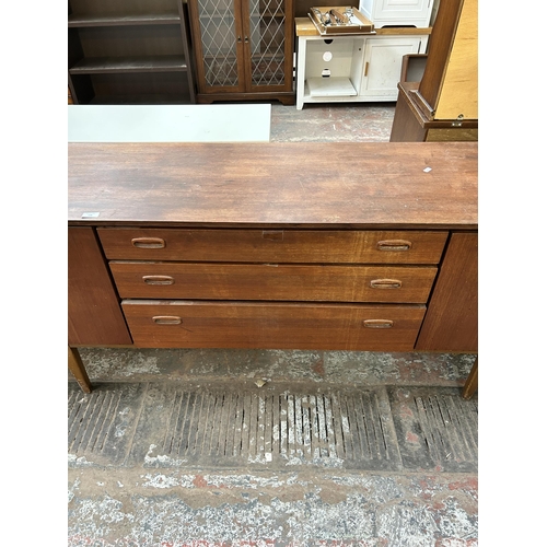 92 - A mid 20th century Nathan teak sideboard with three central drawers and two outer cupboard doors - a... 