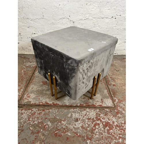 98 - A modern grey fabric storage stool with gold painted supports