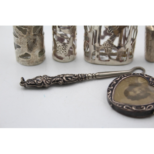 1298 - Six hallmarked sterling silver ladies vanity items to include button hook, miniature photo frame etc... 