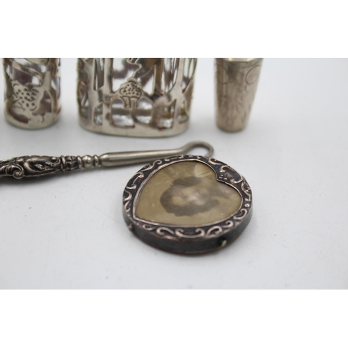 1298 - Six hallmarked sterling silver ladies vanity items to include button hook, miniature photo frame etc... 