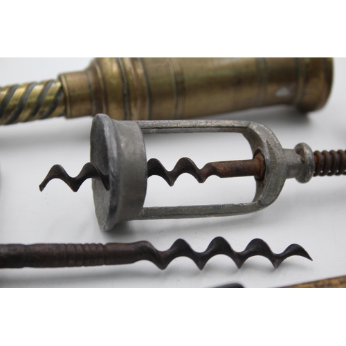 1342 - Five antique and vintage corkscrews to include horn, brass, wood etc.