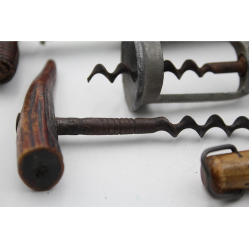 1342 - Five antique and vintage corkscrews to include horn, brass, wood etc.