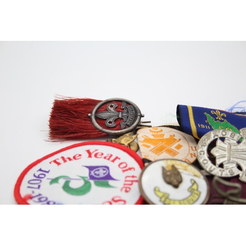 1354 - A collection of Boy Scouts badges, shoulder titles and patches to include Collins London stamped sil... 