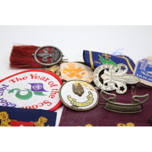 1354 - A collection of Boy Scouts badges, shoulder titles and patches to include Collins London stamped sil... 