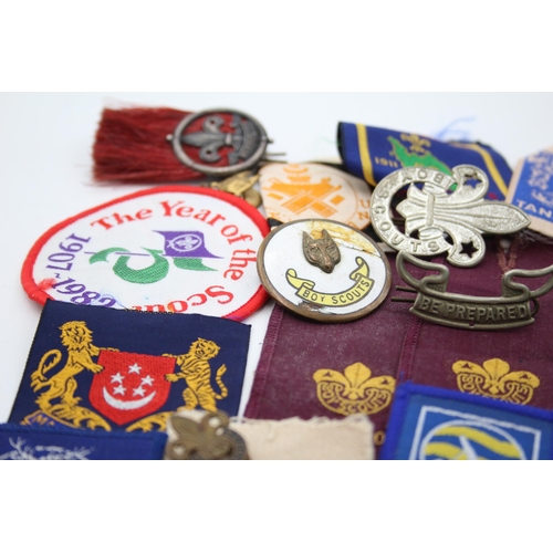 1354 - A collection of Boy Scouts badges, shoulder titles and patches to include Collins London stamped sil... 