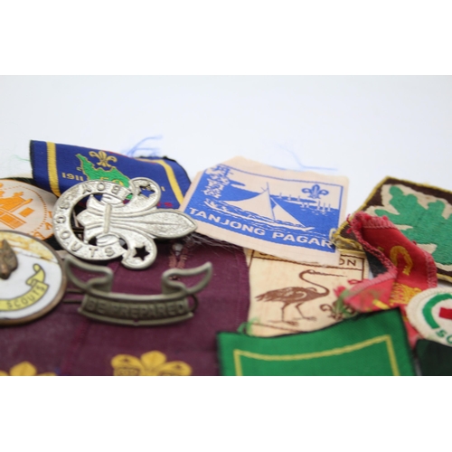 1354 - A collection of Boy Scouts badges, shoulder titles and patches to include Collins London stamped sil... 