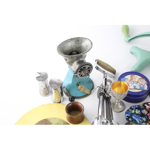 261 - A collection of vintage kitchenware to include meat grinder, whisk, Picquot ware etc.