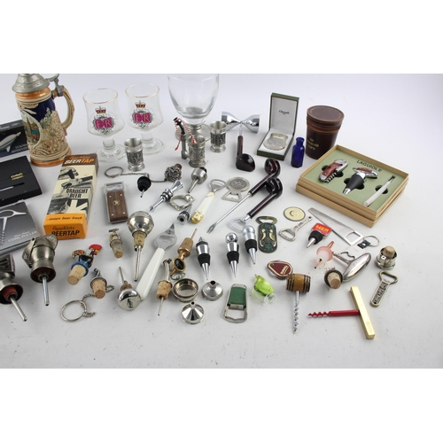 549 - A collection of breweriana to include stein, bottle stopper, spirit measure etc.