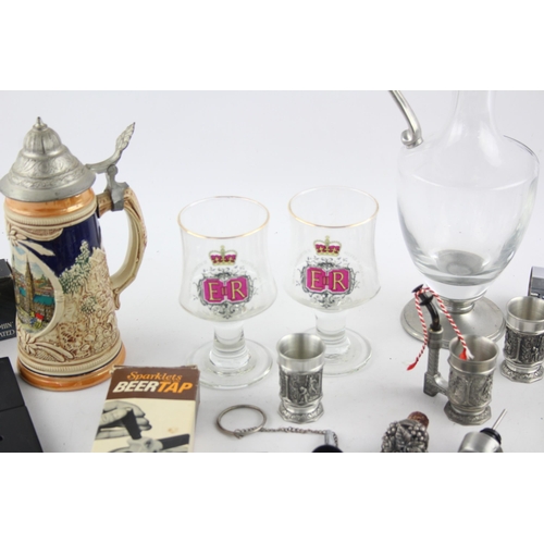 549 - A collection of breweriana to include stein, bottle stopper, spirit measure etc.