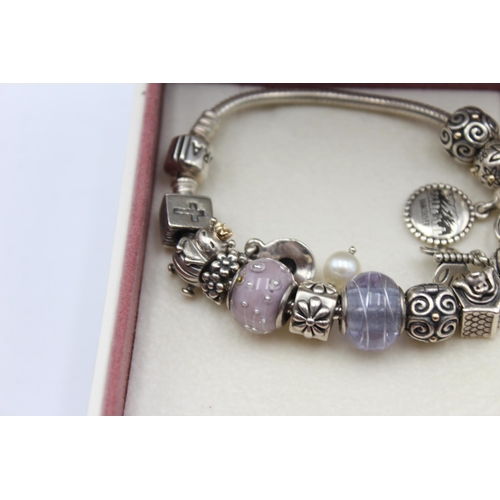 1152 - A Pandora .925 silver bracelet with charms - approx. gross weight 60 grams