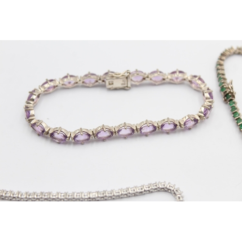 1163 - Four .925 silver tennis bracelets to include emerald etc. - approx. gross weight 38 grams