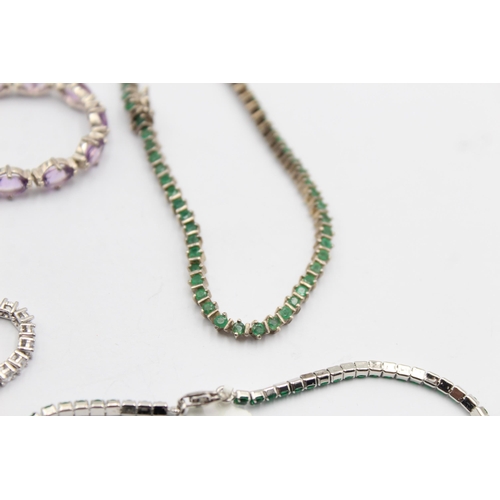 1163 - Four .925 silver tennis bracelets to include emerald etc. - approx. gross weight 38 grams