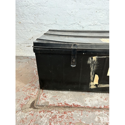 153 - A vintage black metal travel trunk