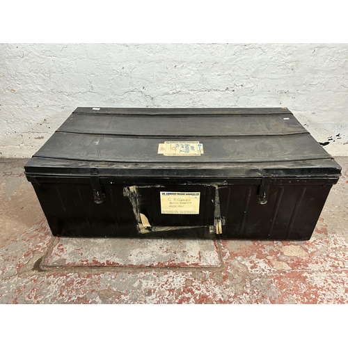 153 - A vintage black metal travel trunk