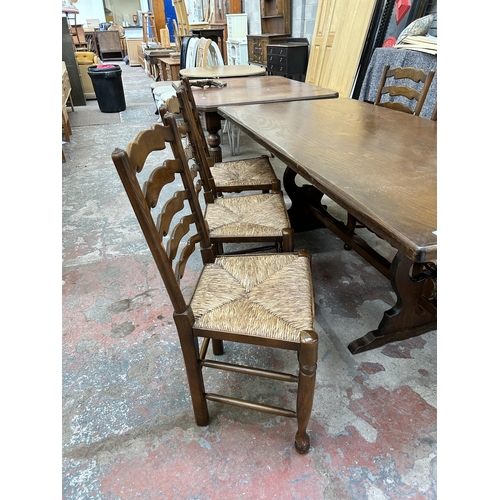 1 - An oak twin pedestal rectangular dining table and six 19th century style elm and beech rush seated L... 