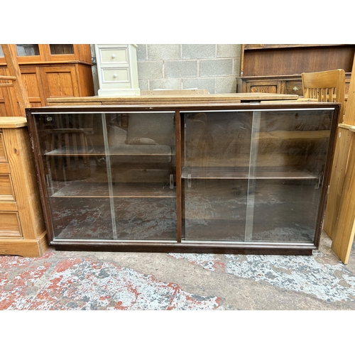 10 - A Minty mahogany bookcase with four glass sliding doors