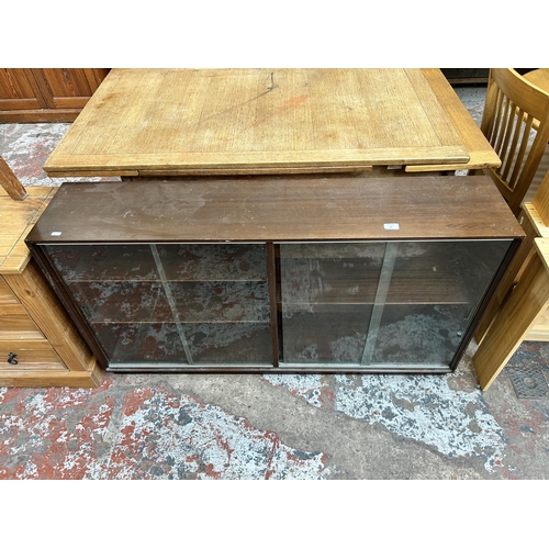 10 - A Minty mahogany bookcase with four glass sliding doors