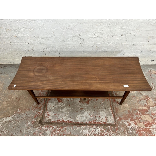 110 - A mid 20th century teak rectangular two tier coffee table