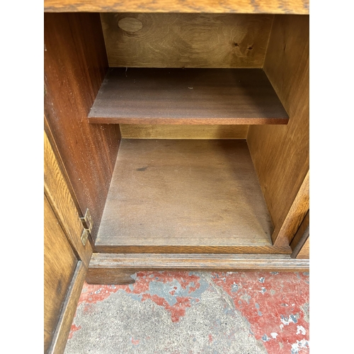 111 - A Georgian style oak sideboard with six drawers and two cupboard doors