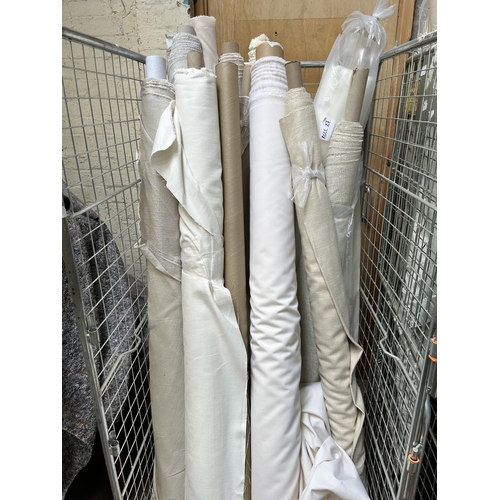 19 - Two cages containing a large quantity of rolls of fabric