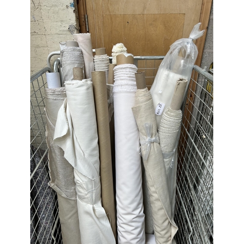 19 - Two cages containing a large quantity of rolls of fabric