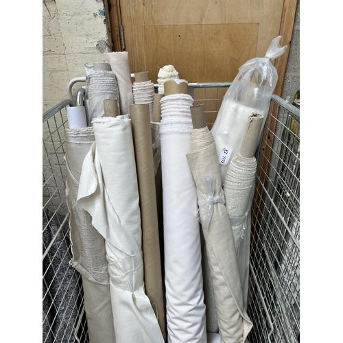 19 - Two cages containing a large quantity of rolls of fabric