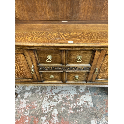 22 - An early 20th century oak dresser with upper plate rack, two drawers and two lower cupboard doors - ... 