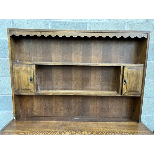 22 - An early 20th century oak dresser with upper plate rack, two drawers and two lower cupboard doors - ... 