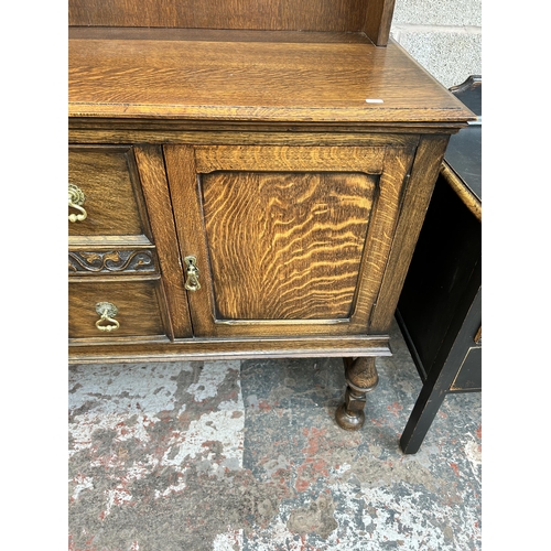 22 - An early 20th century oak dresser with upper plate rack, two drawers and two lower cupboard doors - ... 