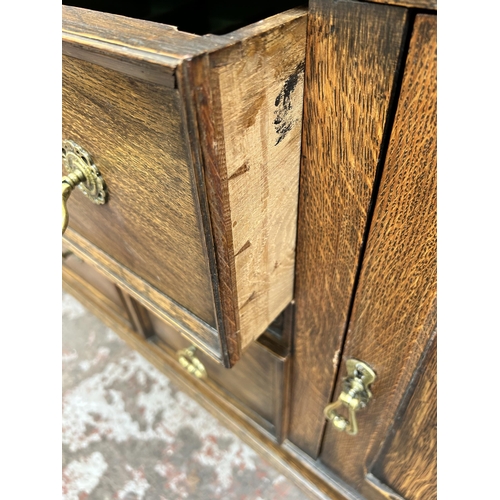 22 - An early 20th century oak dresser with upper plate rack, two drawers and two lower cupboard doors - ... 