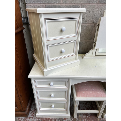 23 - A modern white painted pine five piece bedroom suite comprising dressing table, bedside chest of two... 