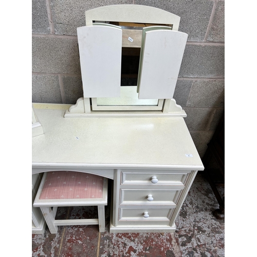 23 - A modern white painted pine five piece bedroom suite comprising dressing table, bedside chest of two... 