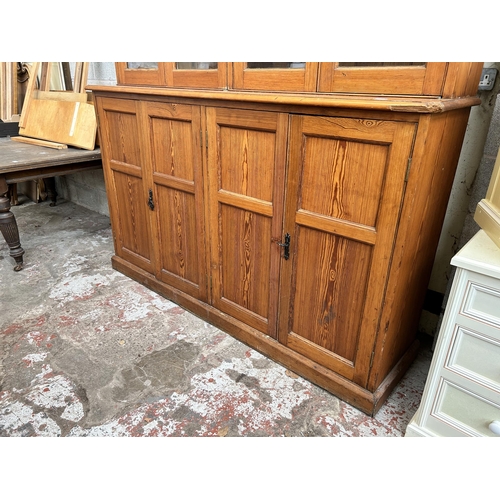 24 - A Victorian pitch pine school cupboard with four upper glazed doors and four lower cupboard doors - ... 