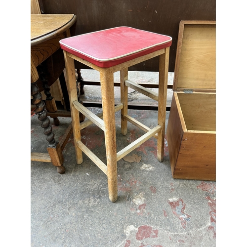 28 - Three pieces of mid 20th century furniture, one oak circular sewing table, one beech and red vinyl k... 